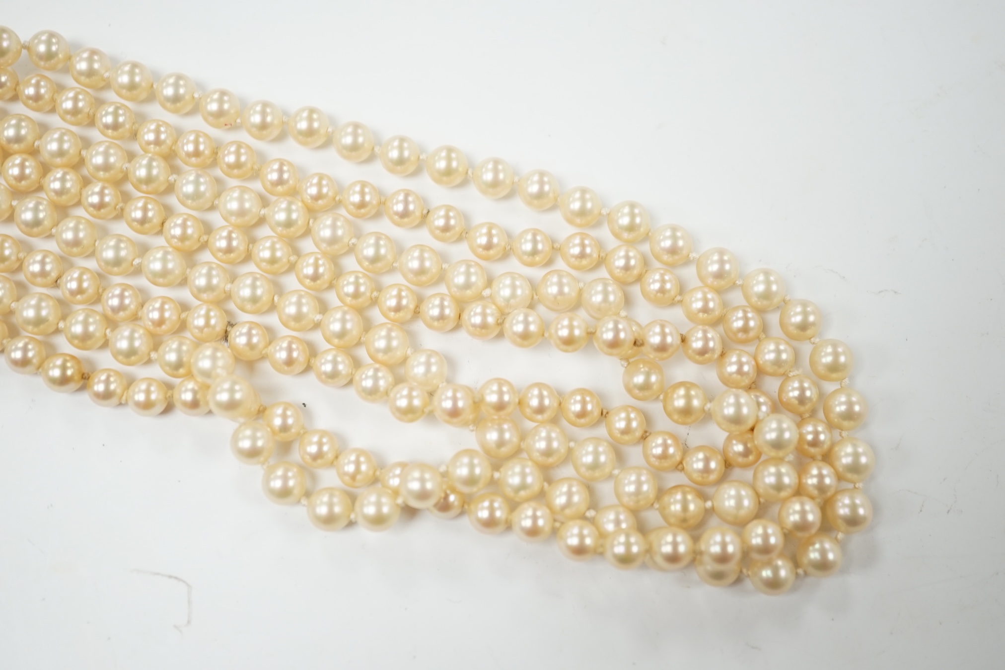 A double strand simulated pearl necklace, with diamond cluster set white metal clasp, 90cm. Condition - fair